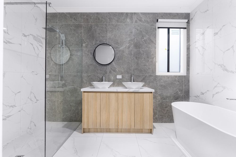 Modern remodeled bathroom with a floating vanity and freestanding tub